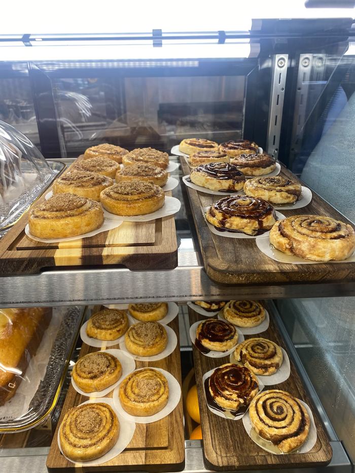Trays of homemade swirl pastries, some topped with walnuts and some with chocolate