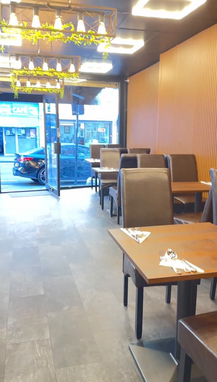 Pasha dining room with set tables, leather chairs and a wooden slatted wall