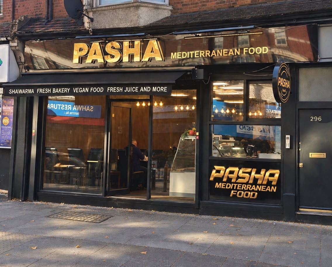 Pasha shopfront in the sunshine, with the gold Pasha Mediterranean Food sign above the windows